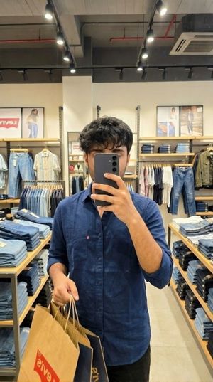 Make it look like I am shopping at Levi's holding bags, taking a picture at the mirror in the store, covering my face with my phone, make...
