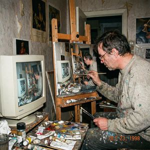 Amateur photograph from 1998 of a middle-aged artist copying an image by hand from a computer screen to an oil painting on stretched canv...