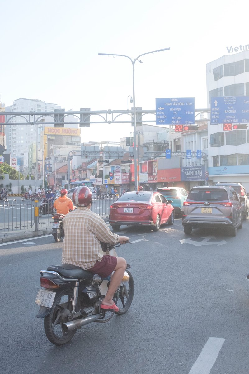 Edit city photo into rainy scene with Vietnamese bikers - Image 1