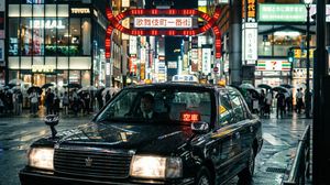 Photograph a taxi stopped on Yasukuni-dori in front of Kabukicho Ichibangai on a rainy night, from a front diagonal angle with cinematic ...