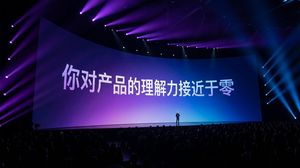 Generate a photo based on some text: a grand Apple keynote event scene, with many people in the audience. The scene is dark with gorgeous...