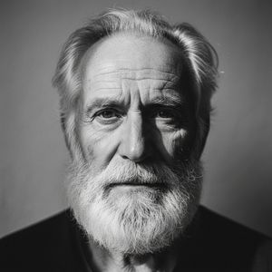 Black and white portrait of an elderly bearded man, full face, deep set eyes, fine wrinkles, strong natural light from a side, high resol...