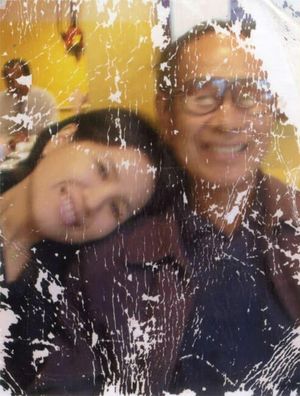 Restore this old, heavily damaged photo by removing all visible scratches, dents, folds, and stains. Reconstruct missing or distorted fac...